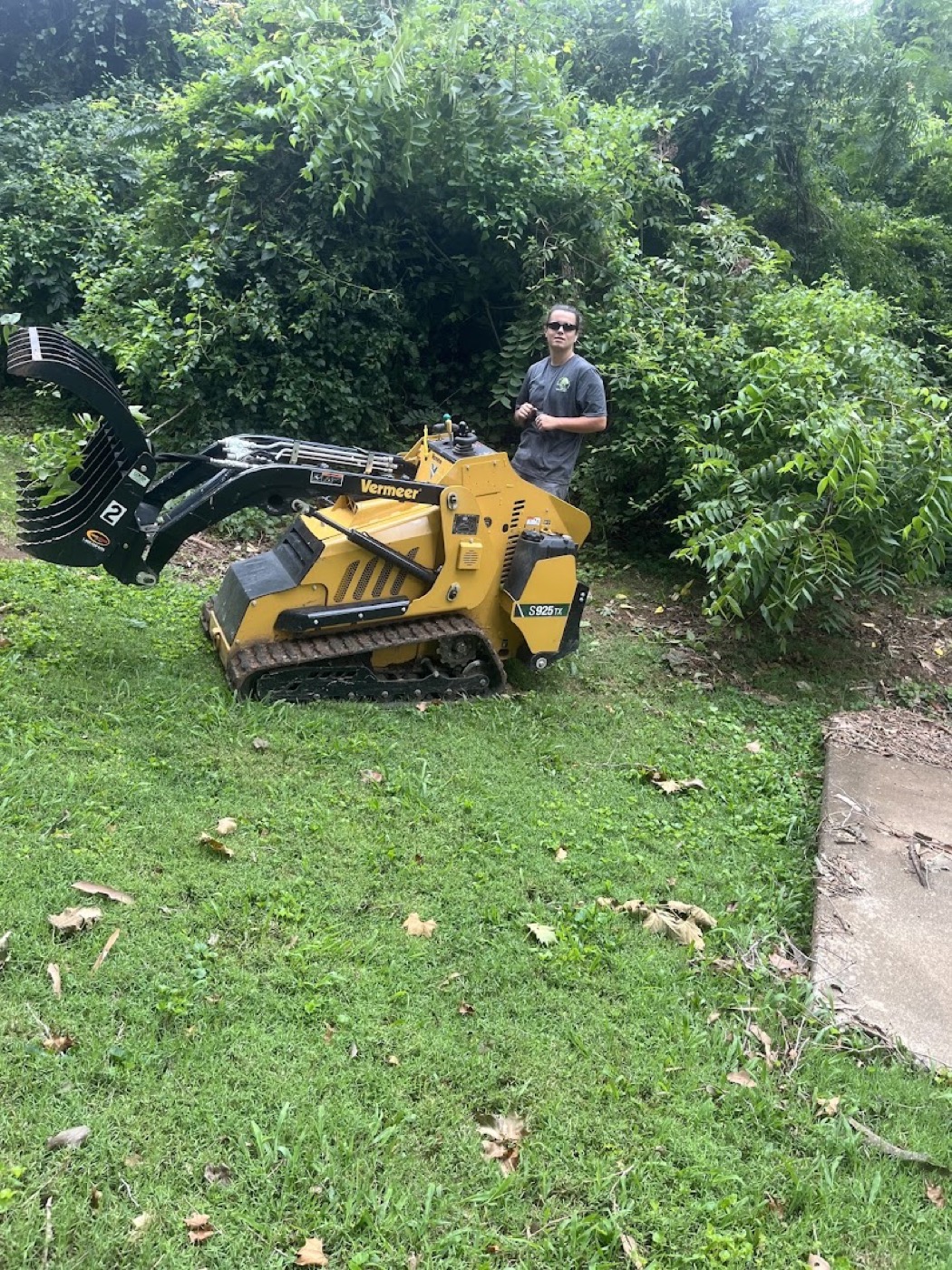 A track loader clearing brush and land on a Powell lot
