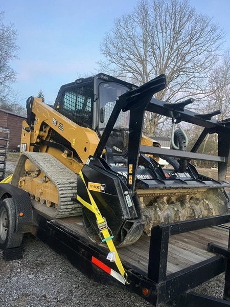 The Elite Tree Service mulching head and skid steer loaded for a job